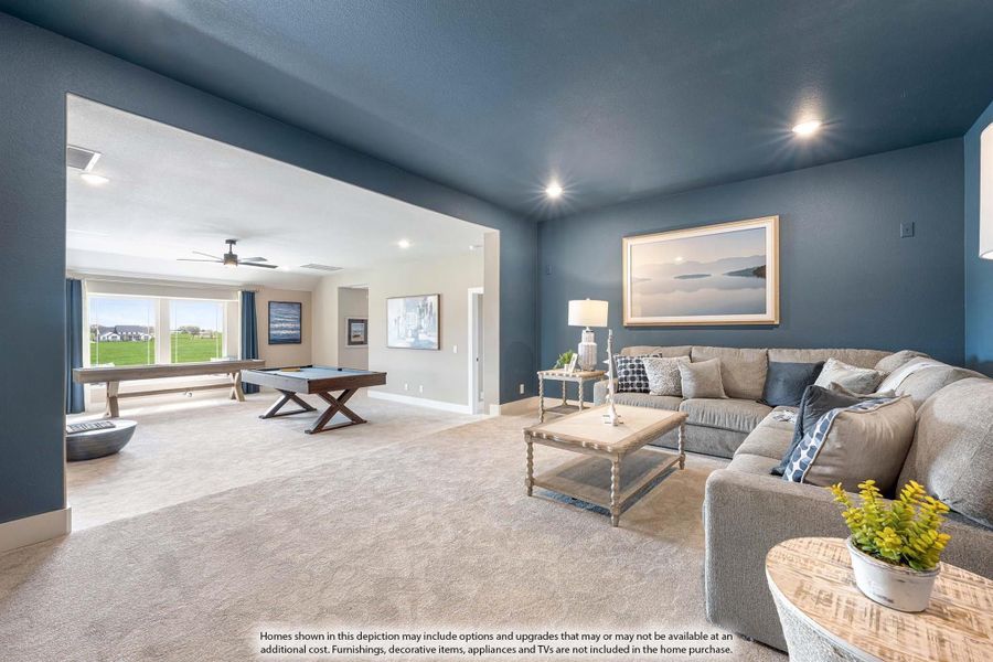 Spacious game room with pool table, sectional sofa, blue accent walls, and carpet flooring open to a second living area.