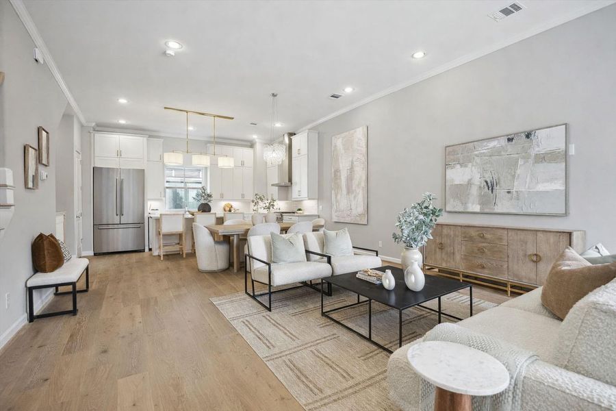 Living room flows seamlessly into dining area and kitchen (fridge is not included).