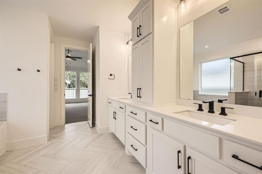 Full bathroom featuring double vanity, baseboards, ceiling fan, a shower with door, and recessed lighting