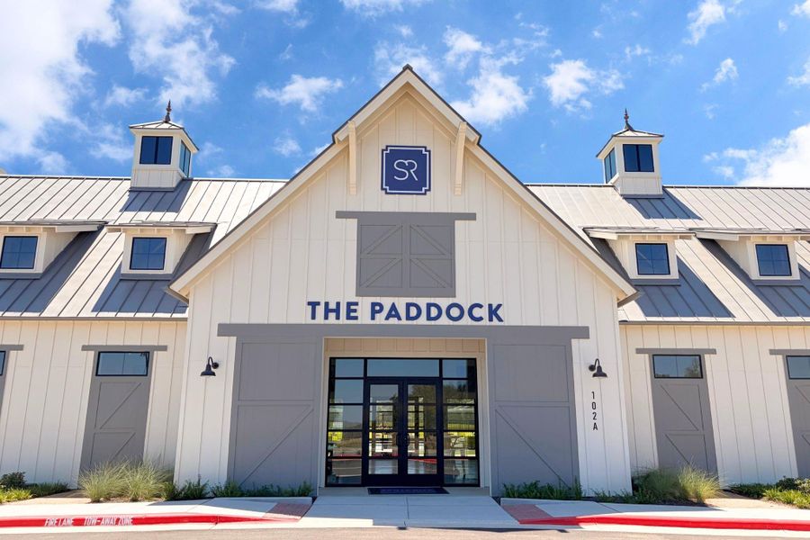 Board and batten siding pairs with a sleek metal roof on this striking modern barn structure.