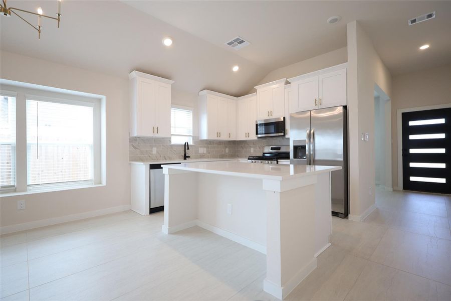 Kitchen with many builder upgrades. Gas cooktop range, ample cabinetry and soft closing cabinets plus drawers.