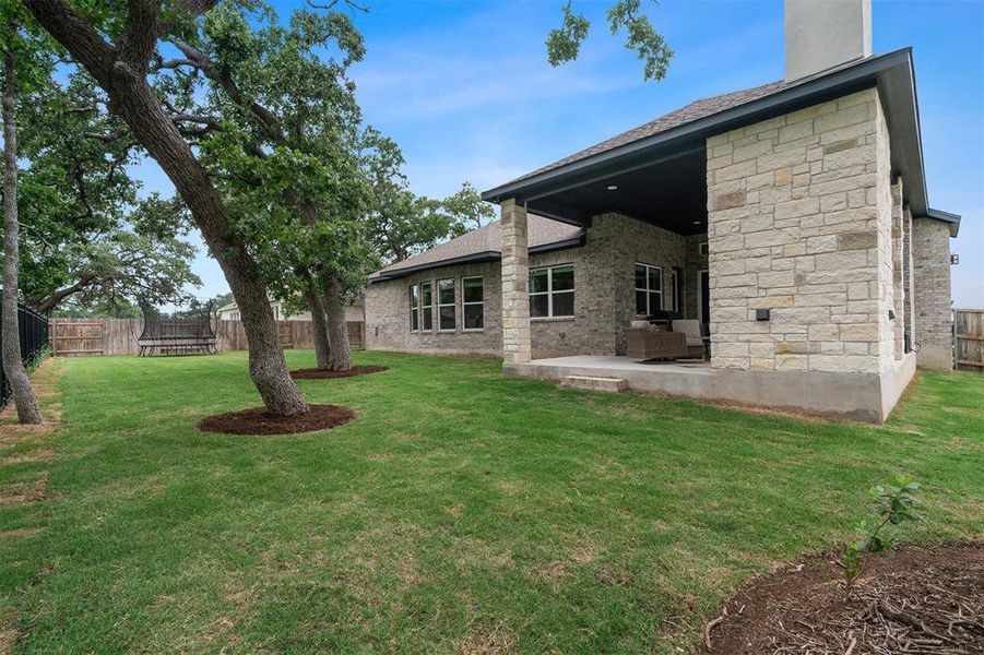 The backyard offers a tranquil retreat, boasting privacy and serenity with no direct back neighbors, allowing for peaceful relaxation and outdoor enjoymen