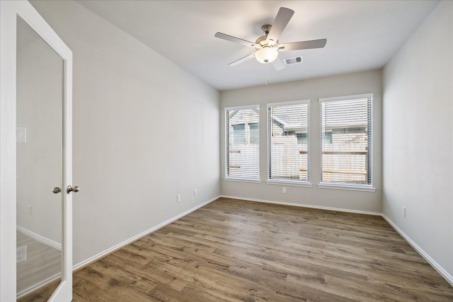 The home office/ study has a glass door for working from home. There is a ceiling fan as well for comfort.