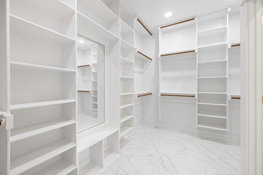 Walk in closet featuring marble finish floor