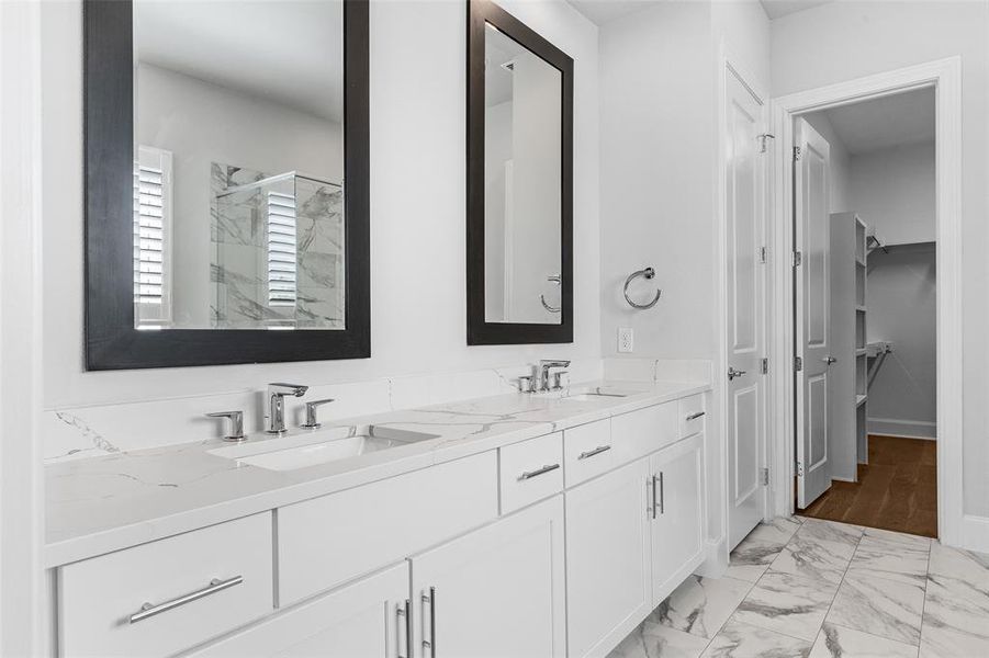 Primary Bathroom with dual sinks and framed mirrors