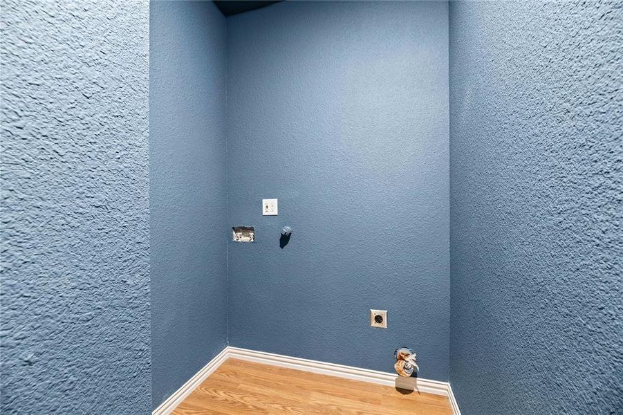 Laundry area with hardwood / wood-style flooring and electric dryer hookup Laundry area with hardwood / wood-style flooring and electric dryer hookup