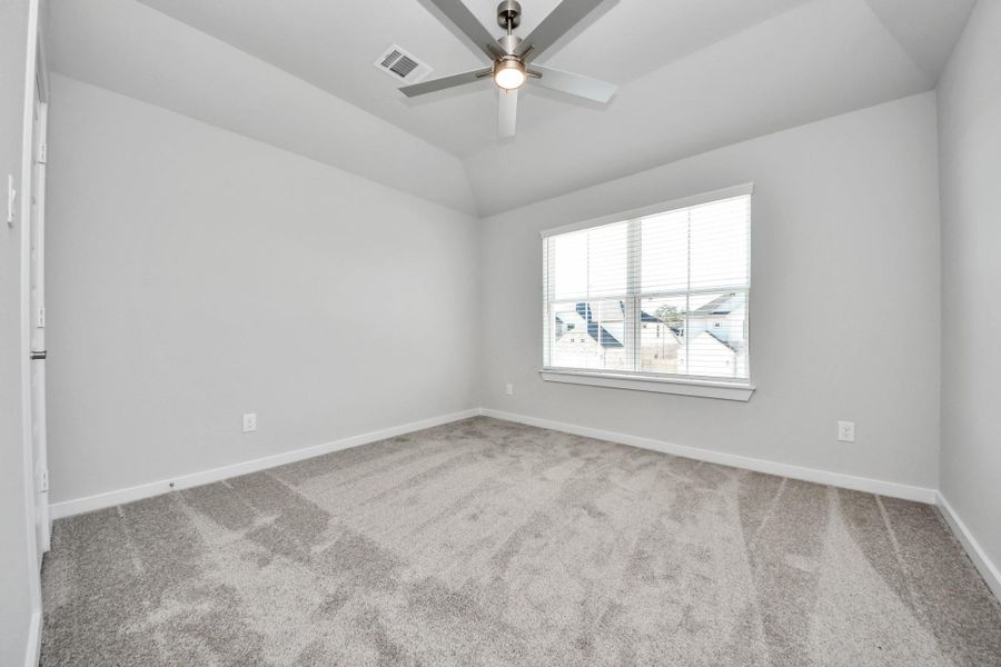 Secondary bedroom features plush carpeting, large windows that let in plenty of natural light, bright paint, and spacious closets.