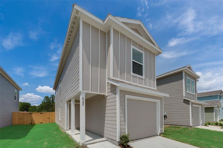 View of front of home featuring a garage and a front lawn