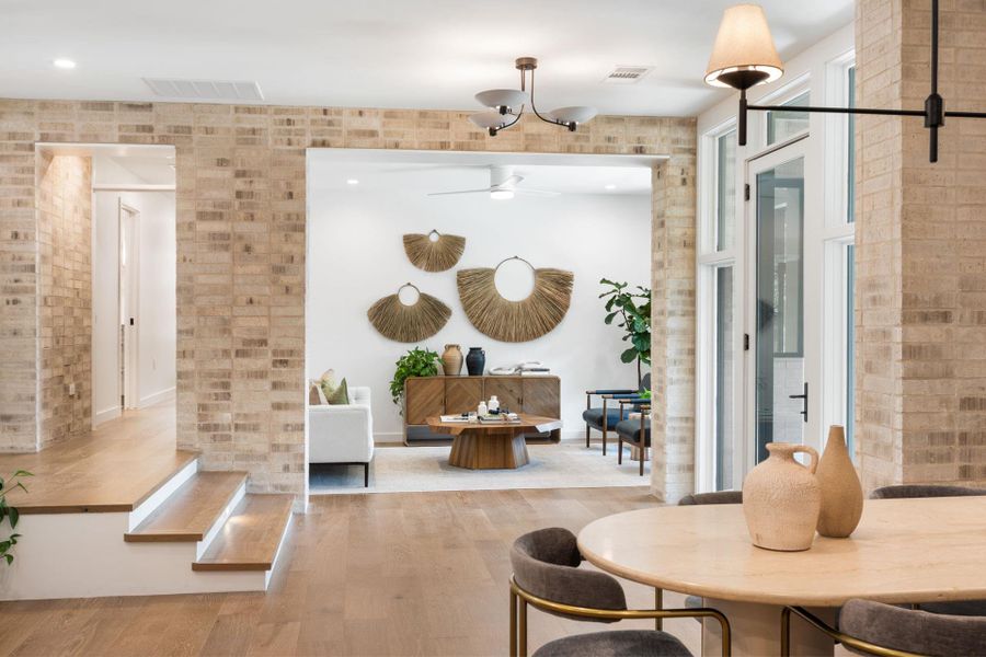 Dining space with wood finished floors and a ceiling fan