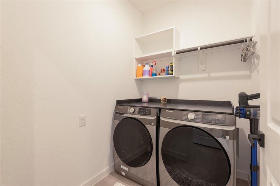 Laundry area featuring washer and dryer and baseboards Laundry area featuring washer and dryer and baseboards