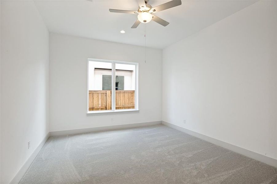 Spacious interior room featuring light gray carpeting and crisp white walls Spacious interior room featuring light gray carpeting and crisp white walls