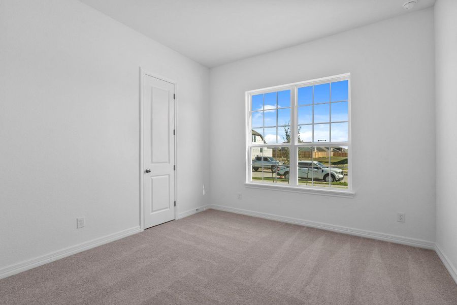 Your secondary bedroom features plush carpet, fresh paint, closet, and a large window that lets in plenty of natural lighting.