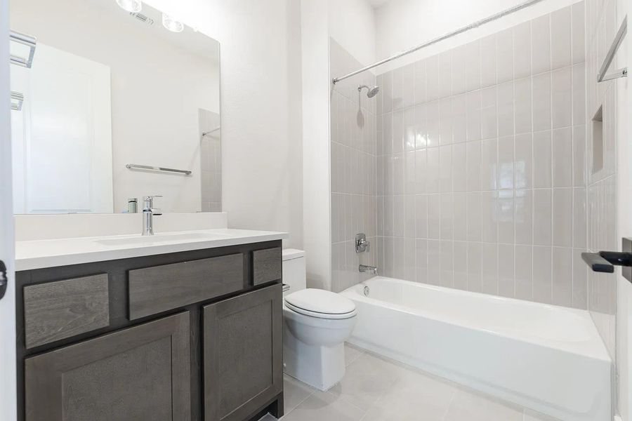 Bathroom with vanity, shower / tub combination, and tile patterned floors Bathroom with vanity, shower / tub combination, and tile patterned floors