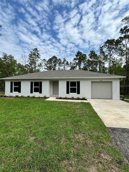 Front exterior of a new home in Flagler Estates, Hastings, FL, highlighting curb appeal (Image 1). Front exterior of a new home in Flagler Estates, Hastings, FL, highlighting curb appeal (Image 1).
