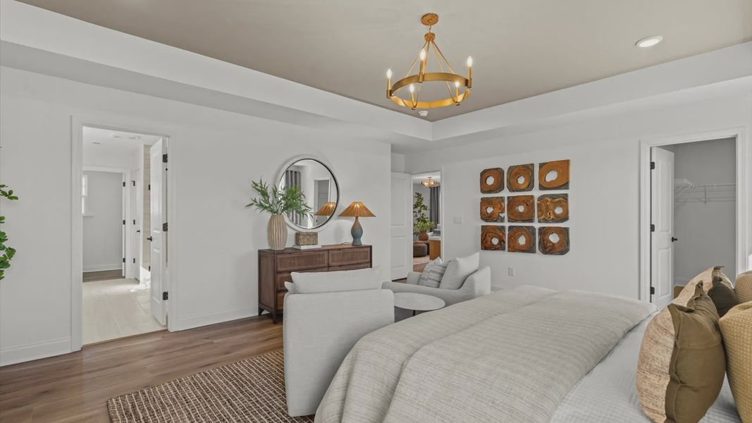 Wynwood home plan expansive primary suite with tray ceiling, sitting room, walk-in closet, and luxury en suite bathroom Wynwood home plan expansive primary suite with tray ceiling, sitting room, walk-in closet, and luxury en suite bathroom