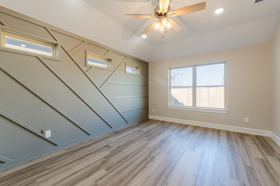 Unfurnished room featuring ceiling fan, recessed lighting, light wood finished floors, and vaulted ceiling