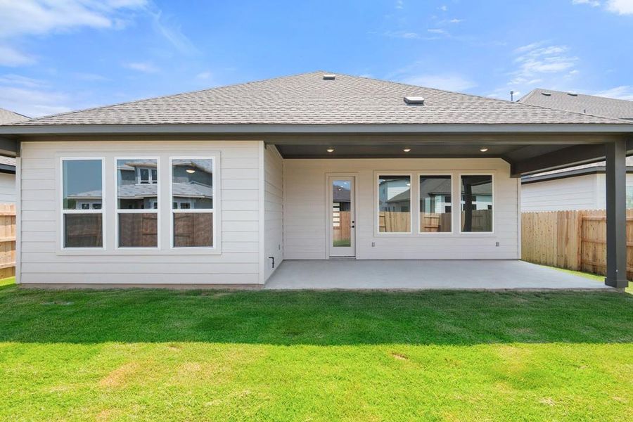 Front exterior of a new home in Lagos Reserve, Manor, TX, highlighting curb appeal (Image 21). Front exterior of a new home in Lagos Reserve, Manor, TX, highlighting curb appeal (Image 21).