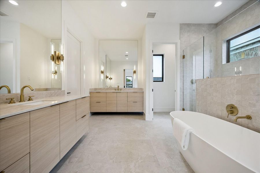 Primary bath – features floating double vanities, a freestanding tub, and a frameless glass walk-in shower. Primary bath – features floating double vanities, a freestanding tub, and a frameless glass walk-in shower.