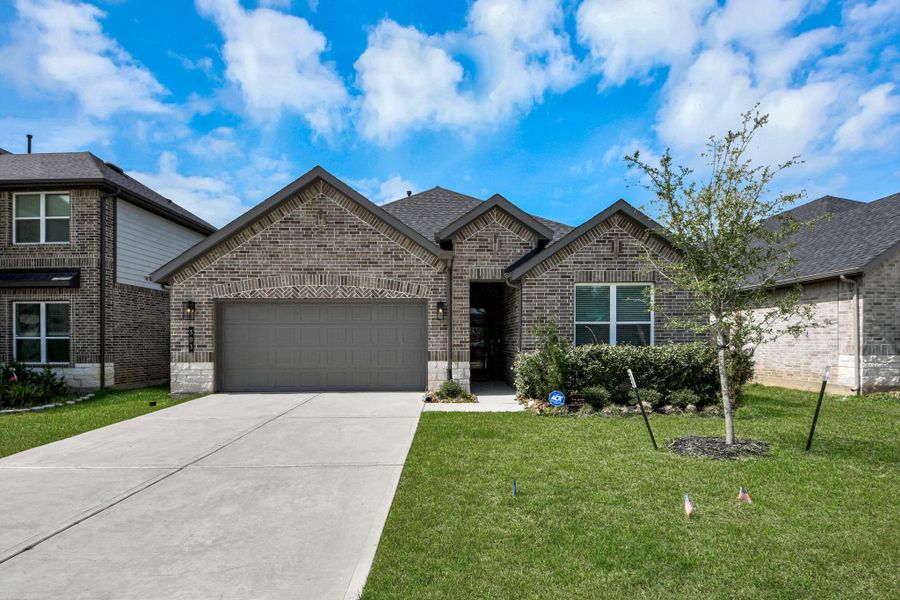 Front exterior of a new home in Hills of Westlake, Conroe, TX, highlighting curb appeal (Image 1). Front exterior of a new home in Hills of Westlake, Conroe, TX, highlighting curb appeal (Image 1).