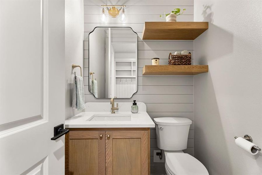 Bathroom featuring vanity and wood walls