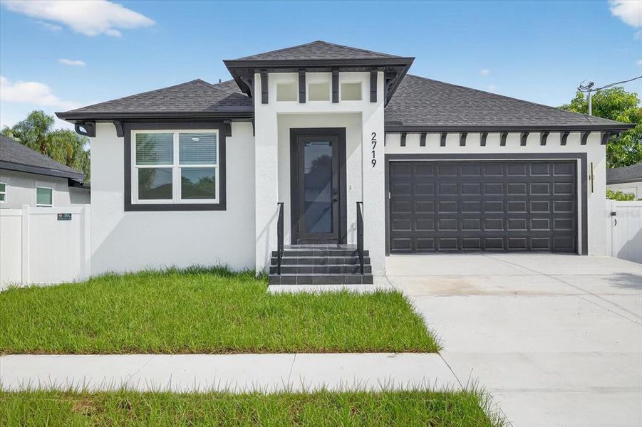 Front exterior of a new home in , Tampa, FL, highlighting curb appeal (Image 24).