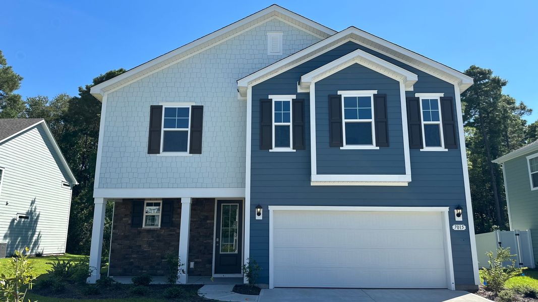 Front exterior of a new home in Waterbridge, Myrtle Beach, SC, highlighting curb appeal (Image 1).