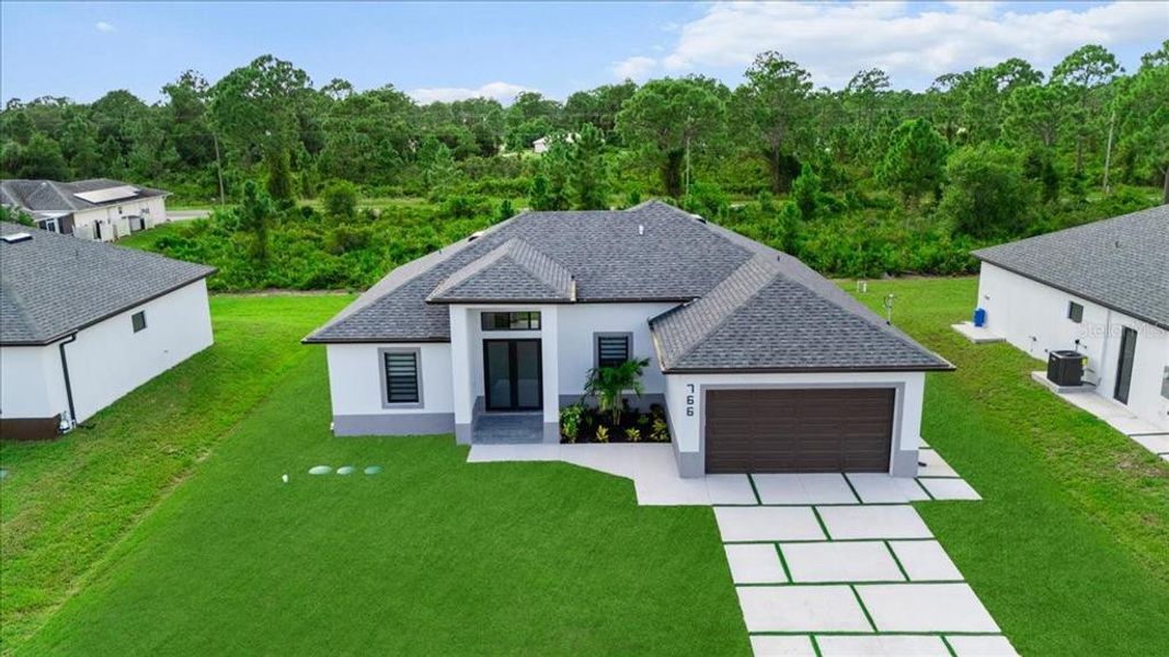 Front exterior of a new home in , Lehigh Acres, FL, highlighting curb appeal (Image 28).