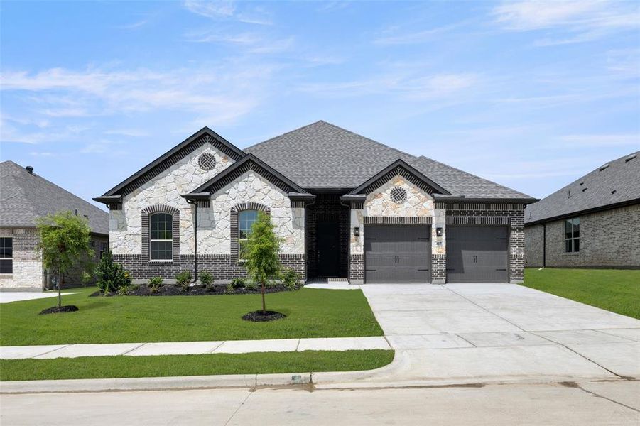 French provincial home with a garage, driveway, a front lawn, and stone siding French provincial home with a garage, driveway, a front lawn, and stone siding