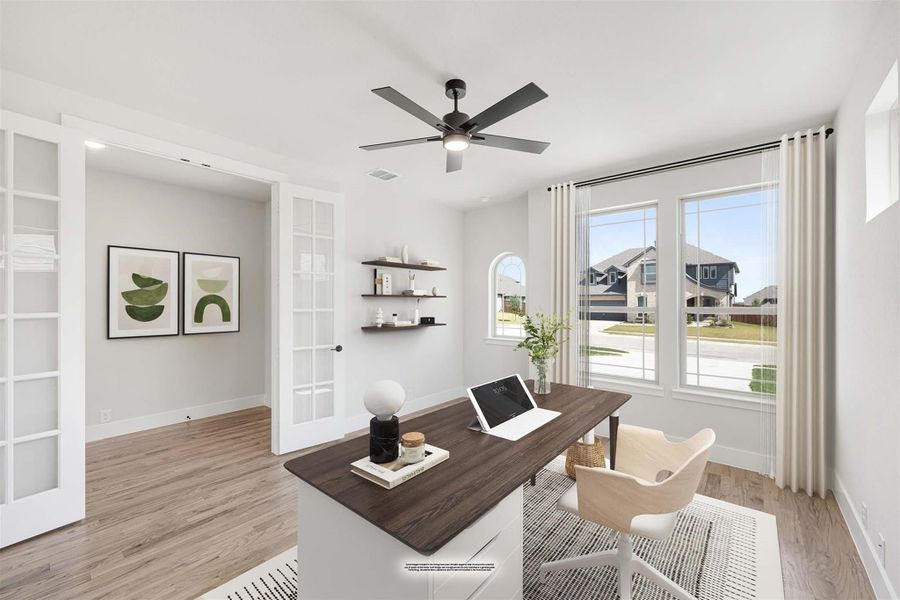 Home office with dark wood desk, ceiling fan, floating shelves, and large windows with neighborhood view