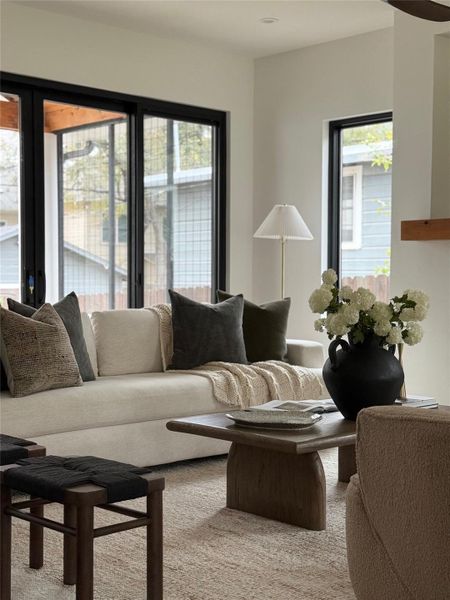 Carpeted living area with plenty of natural light Carpeted living area with plenty of natural light