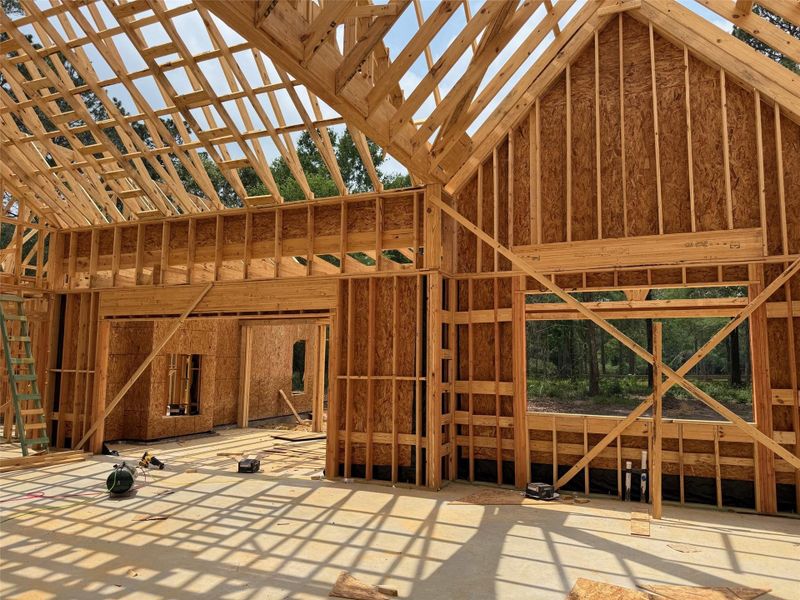 New construction framing showcasing structural wood elements and a vaulted ceiling