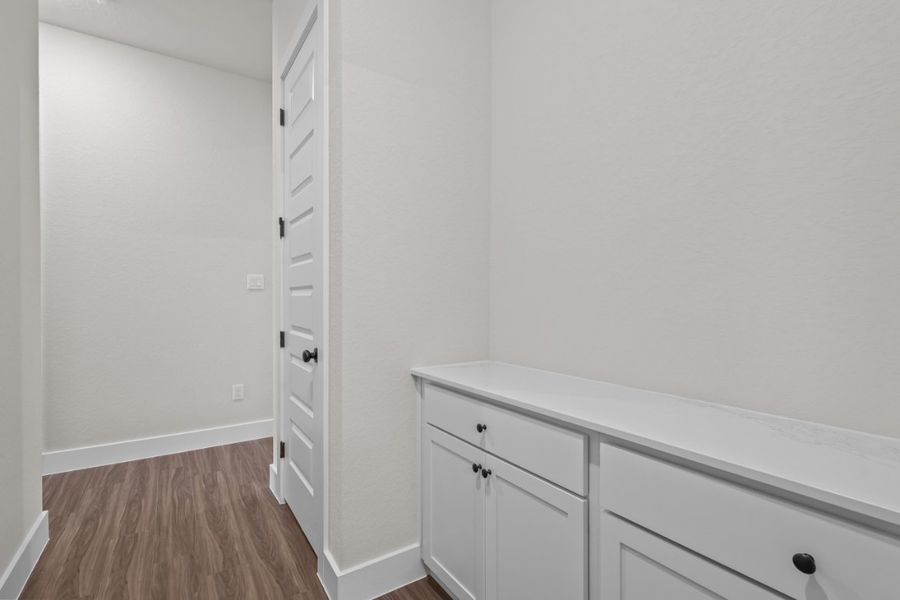 A white dresser in a room. A white dresser in a room.