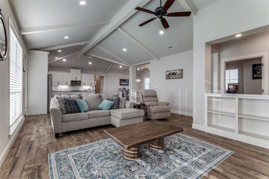 Living room featuring ceiling fan, dark wood finished floors, and recessed lighting