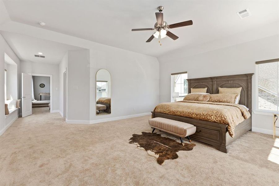 Bedroom featuring light carpet and ceiling fan