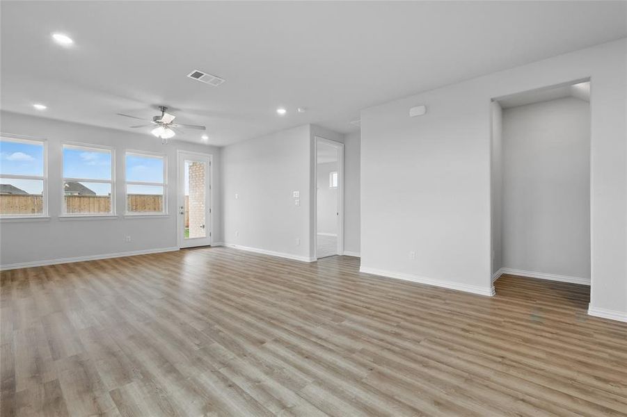 Unfurnished living room featuring recessed lighting, a ceiling fan, and light wood-type flooring Unfurnished living room featuring recessed lighting, a ceiling fan, and light wood-type flooring