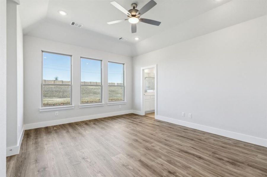 Unfurnished room with ceiling fan, lofted ceiling, and light hardwood / wood-style floors