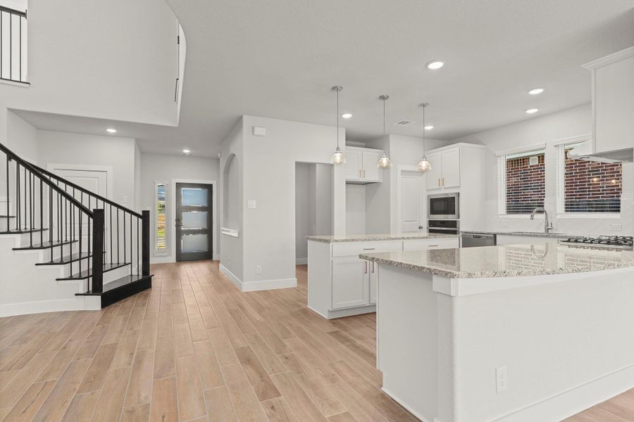 Open-concept living at its finest! The family room flows effortlessly into the gourmet kitchen and dining areas, offering the perfect layout for entertaining or simply enjoying time together at home.