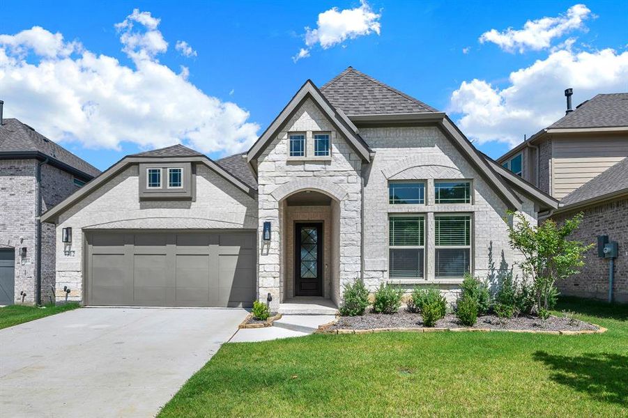 Front exterior of a new home in Union Park, Little Elm, TX, highlighting curb appeal (Image 20). Front exterior of a new home in Union Park, Little Elm, TX, highlighting curb appeal (Image 20).