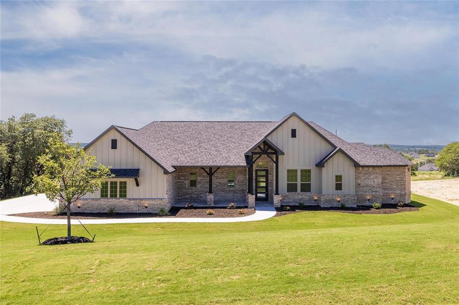 Modern farmhouse style home with a front lawn