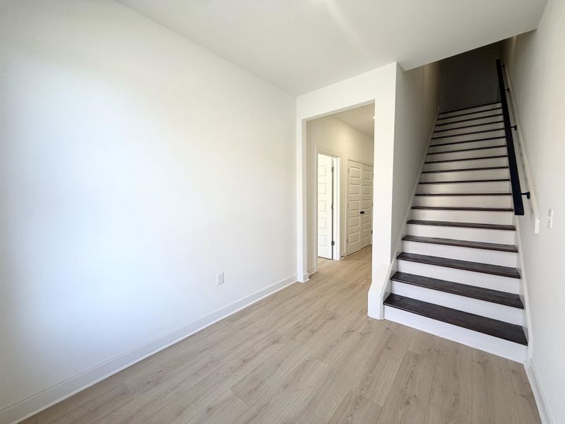 Stairs featuring wood finished floors and baseboards