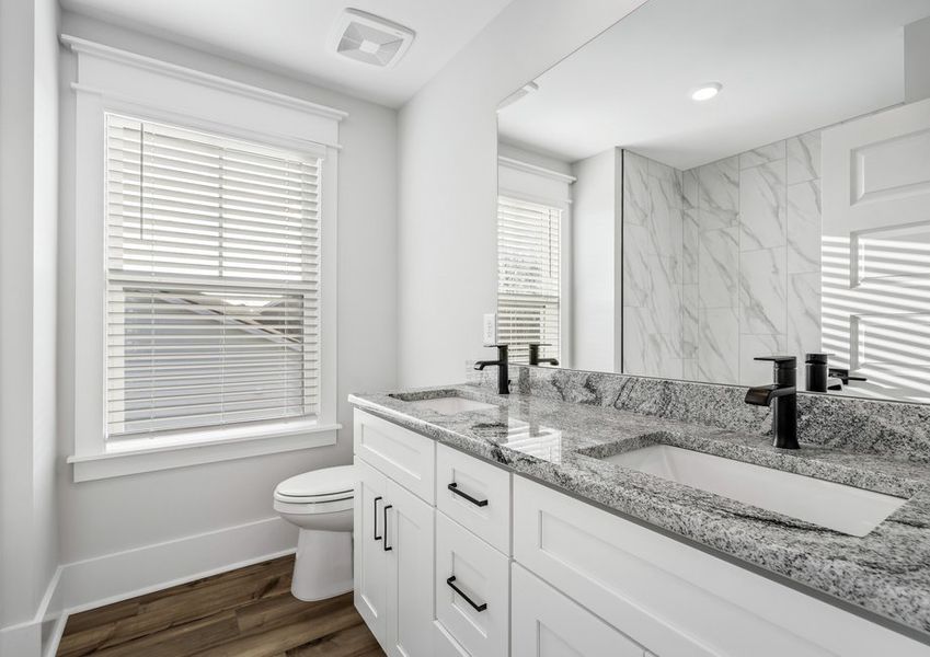 The secondary bathrooms offer ample storage.