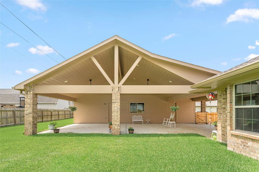 The generously sized covered patio provides abundant shade and shelter from the elements, extending your entertaining footprint well beyond the interior of the home. The striking wood-beam gabled roof structure adds architectural character and a warm, lodge-inspired aesthetic that sets this outdoor space apart from the typical builder-grade patio — this is a destination, not an afterthought. The generously sized covered patio provides abundant shade and shelter from the elements, extending your entertaining footprint well beyond the interior of the home. The striking wood-beam gabled roof structure adds architectural character and a warm, lodge-inspired aesthetic that sets this outdoor space apart from the typical builder-grade patio — this is a destination, not an afterthought.