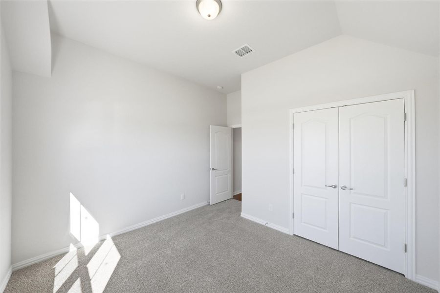 Unfurnished bedroom with carpet and a closet Unfurnished bedroom with carpet and a closet