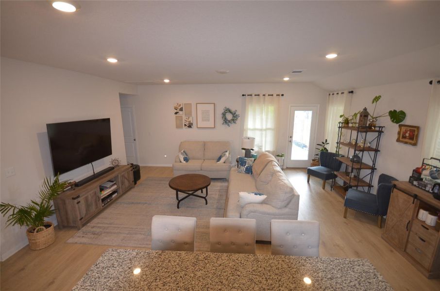 Living room featuring light wood-style floors and recessed lighting Living room featuring light wood-style floors and recessed lighting