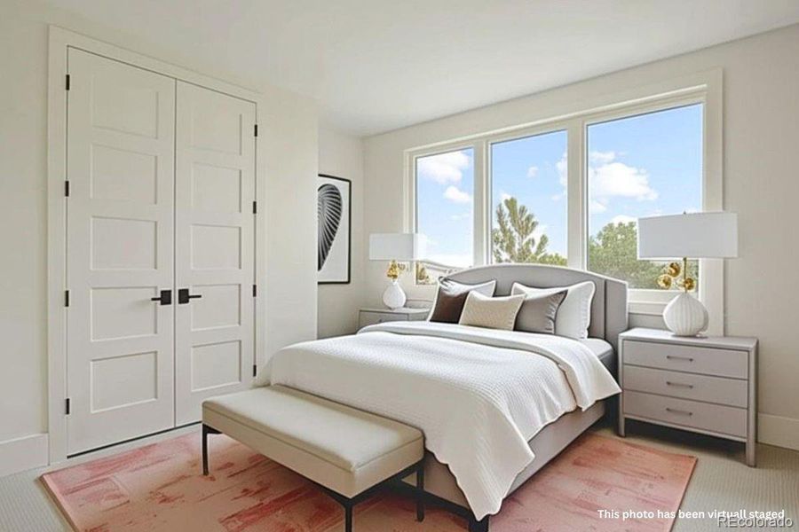 Lower-level bedroom (bedroom 2) with a large closet and en suite bathroom.*This photo has been virtually staged