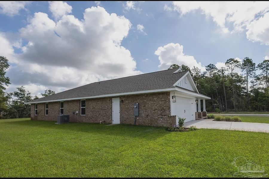 Front exterior of a new home in Hidden Pines, Milton, FL, highlighting curb appeal (Image 2).