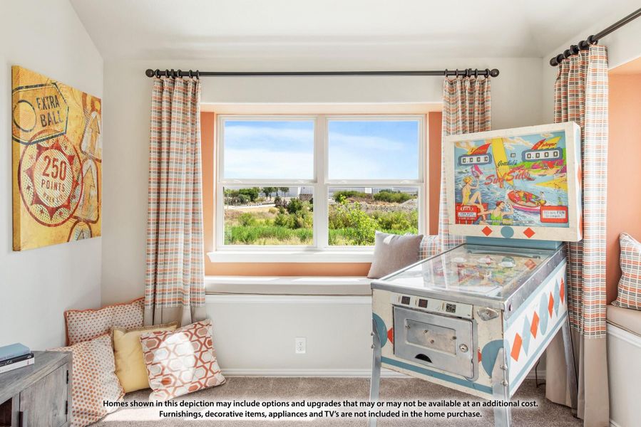 Game room with vintage pinball machine, window seat, and colorful decor overlooking outdoor view Game room with vintage pinball machine, window seat, and colorful decor overlooking outdoor view