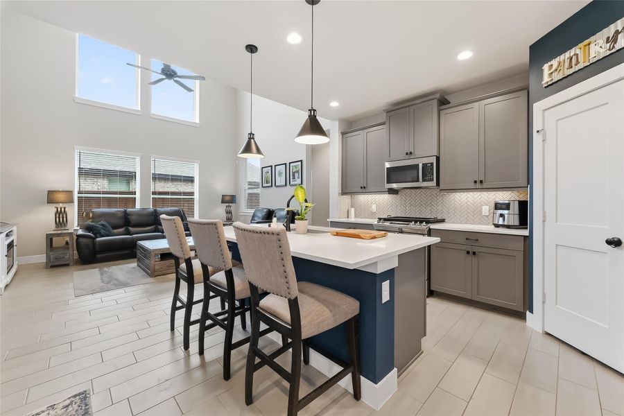cook in the kitchen while still feeling included with this open concept area