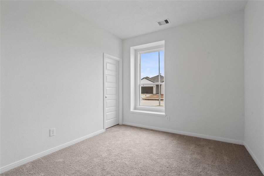 Tucked peacefully in the front of the home is this secondary bedroom! It offers comfort and style with plush carpeting, neutral paint tones, recessed lighting, a large window with window seat, and a walk-in closet. Tucked peacefully in the front of the home is this secondary bedroom! It offers comfort and style with plush carpeting, neutral paint tones, recessed lighting, a large window with window seat, and a walk-in closet.