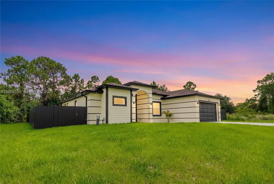 Front exterior of a new home in , Lehigh Acres, FL, highlighting curb appeal (Image 23). Front exterior of a new home in , Lehigh Acres, FL, highlighting curb appeal (Image 23).